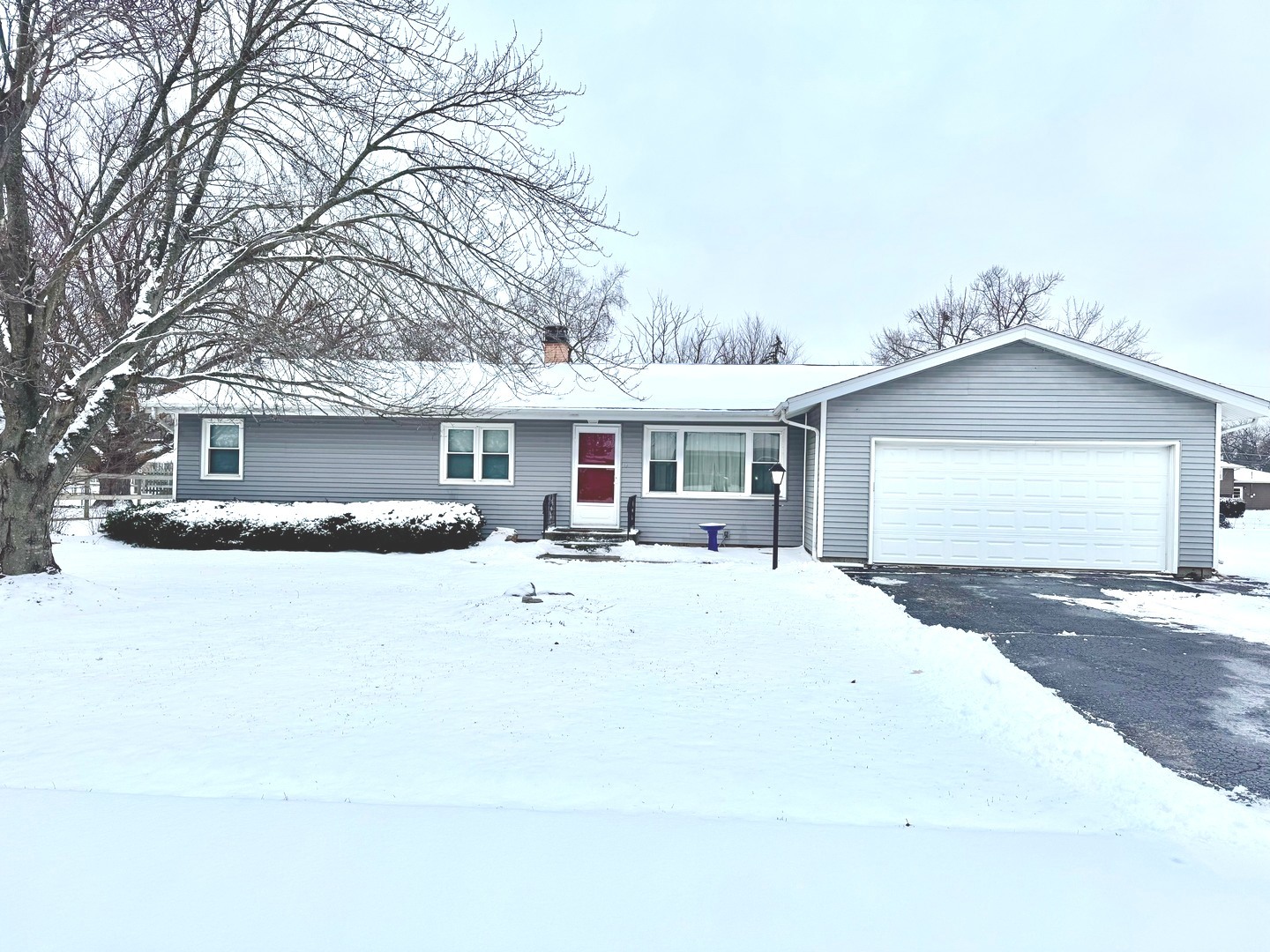 a front view of a house with yard porch and outdoor seating