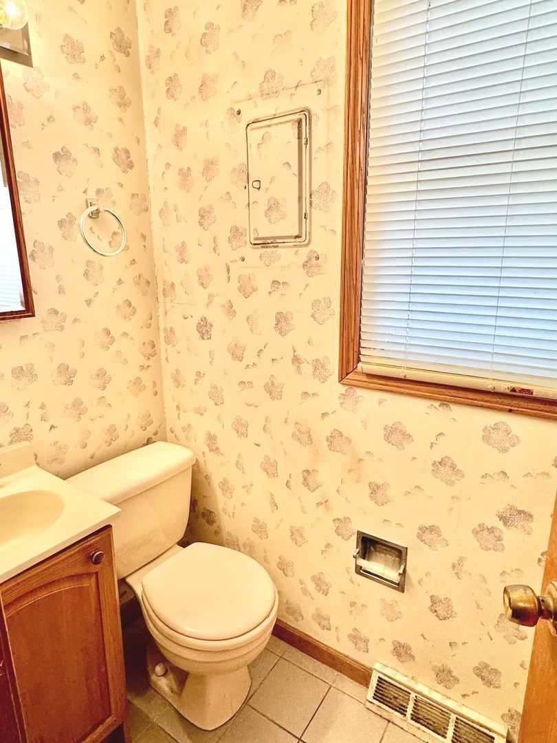 219 William Street New Lenox, IL 60451 - Photo 26 of 29 a white toilet sitting next to a shower curtain