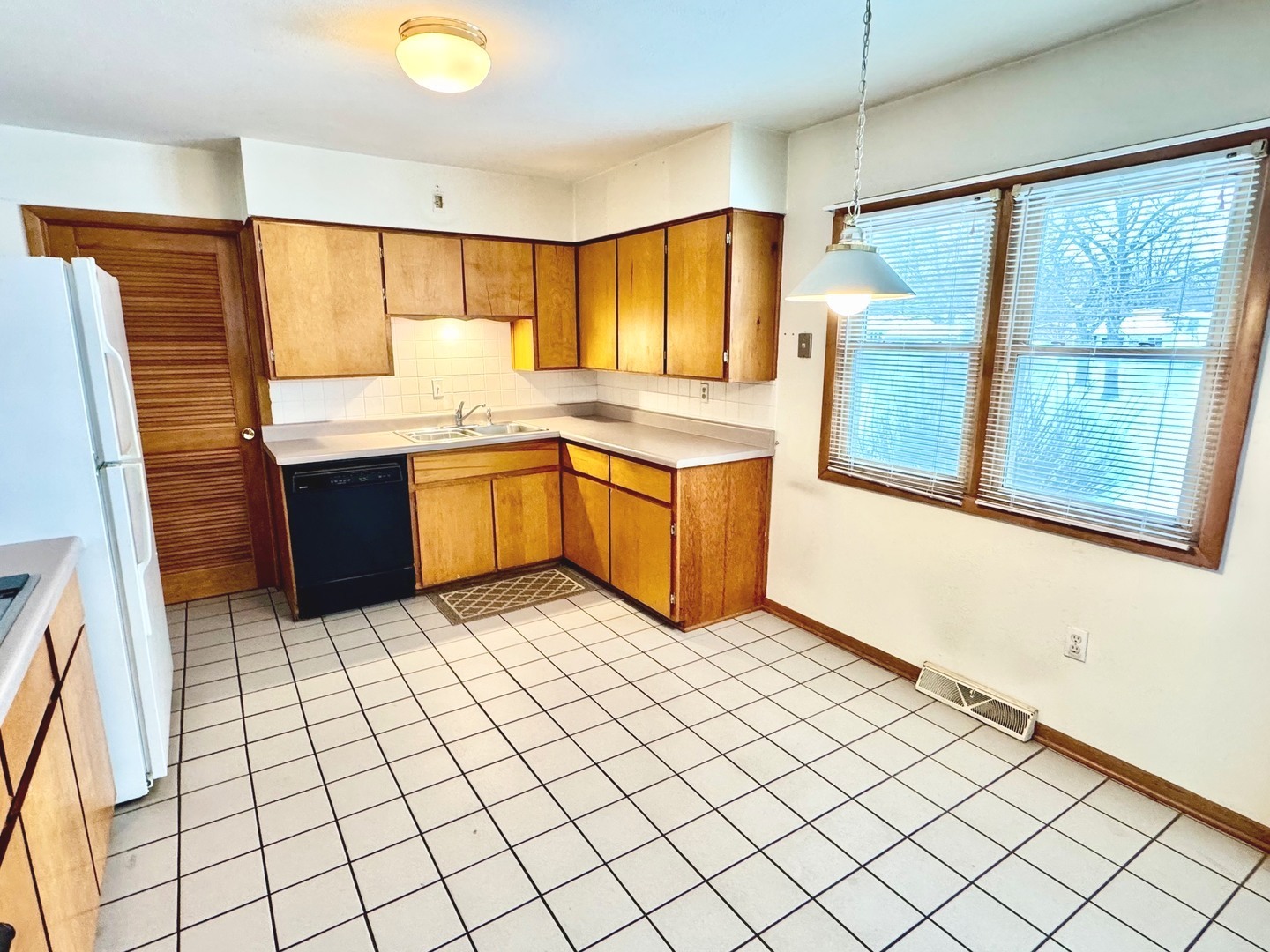 219 William Street New Lenox, IL 60451 - Photo 10 of 29 a kitchen with stainless steel appliances granite countertop a sink and a refrigerator