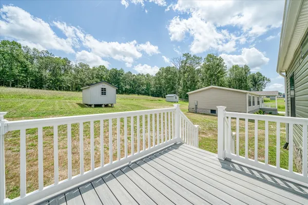 a view of balcony with wooden floor and fence