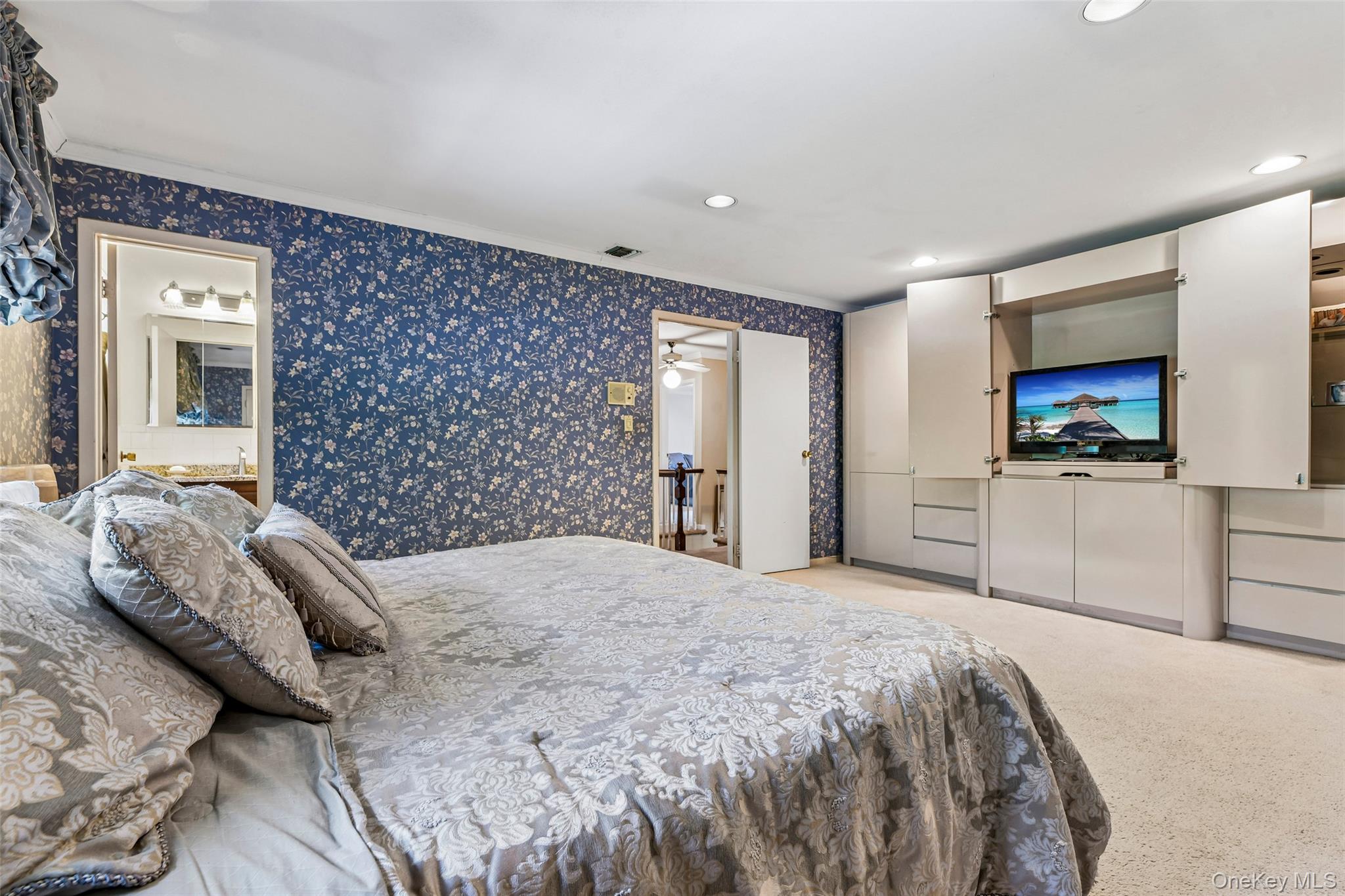 100 Hewlett Neck Road Woodmere, NY 11598 - Photo 24 of 45 a bedroom with a bed and a flat screen tv
