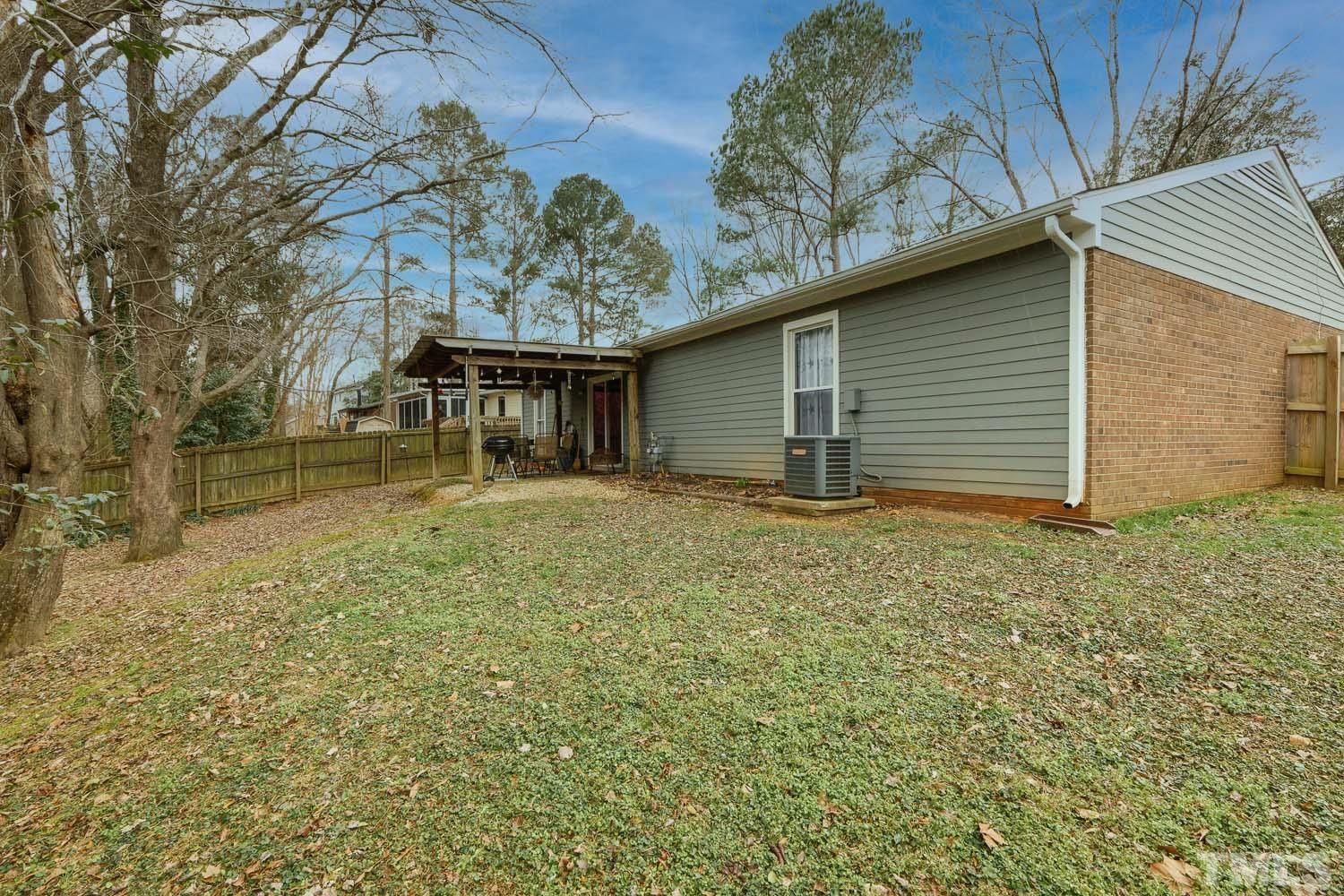 903 Buckhorn Road Garner, NC 27529 - Photo 15 of 15 a backyard of a house with yard and garage