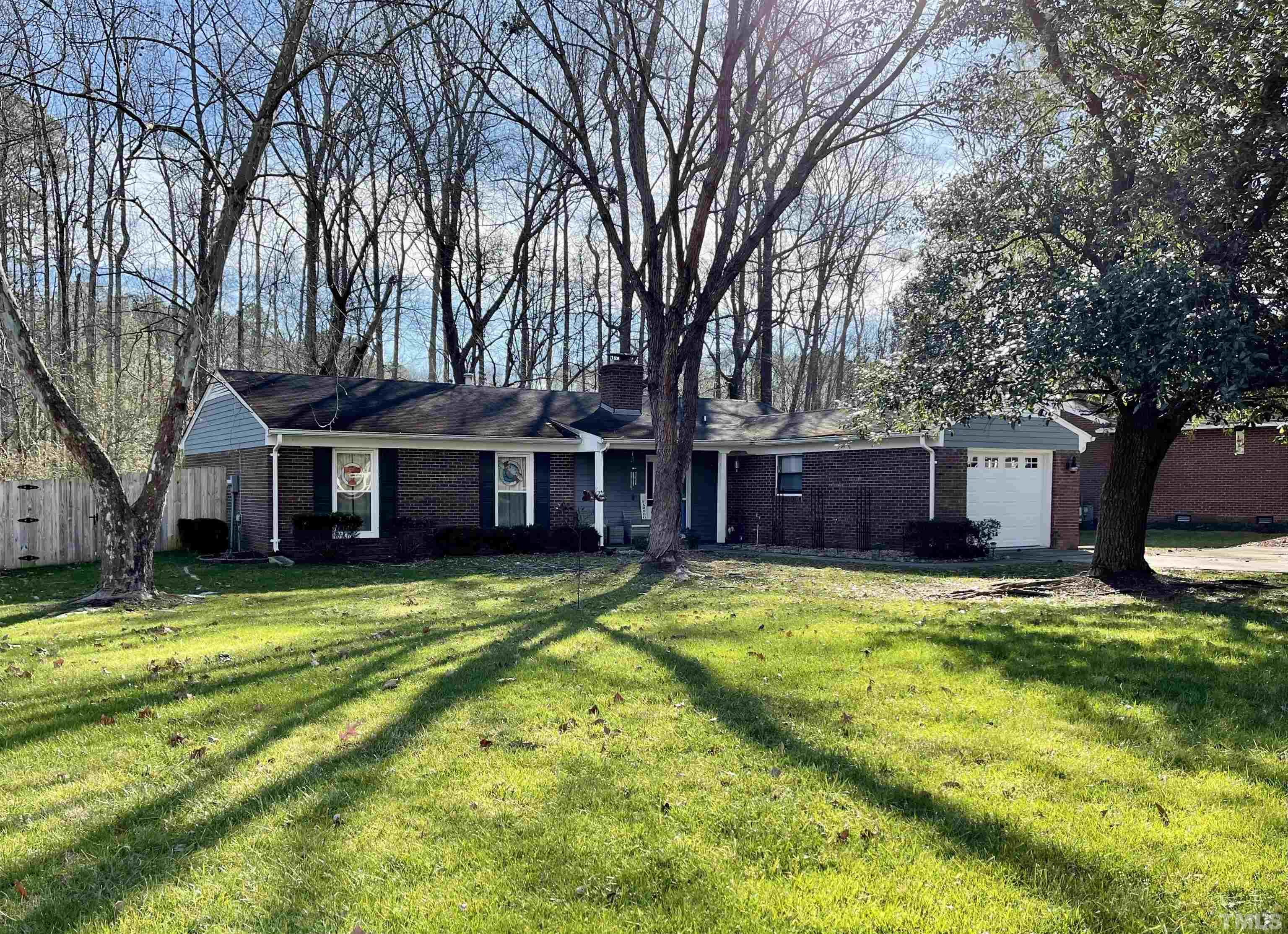 903 Buckhorn Road Garner, NC 27529 - Photo 2 of 15 a view of a house with swimming pool next to a big yard