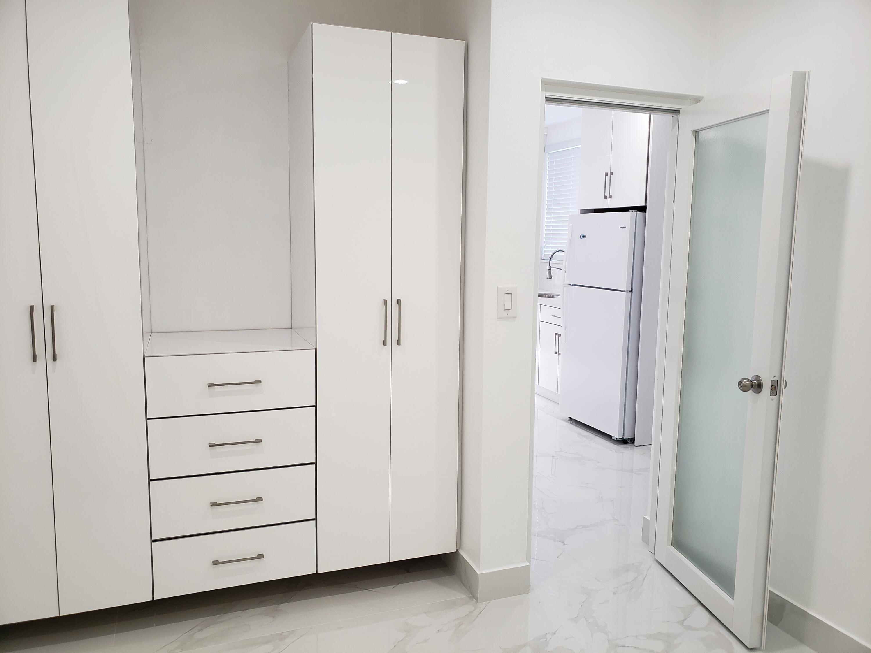 169 Corrine Place Key Largo, FL 33037 - Photo 3 of 6 a view of a closet area with cabinet