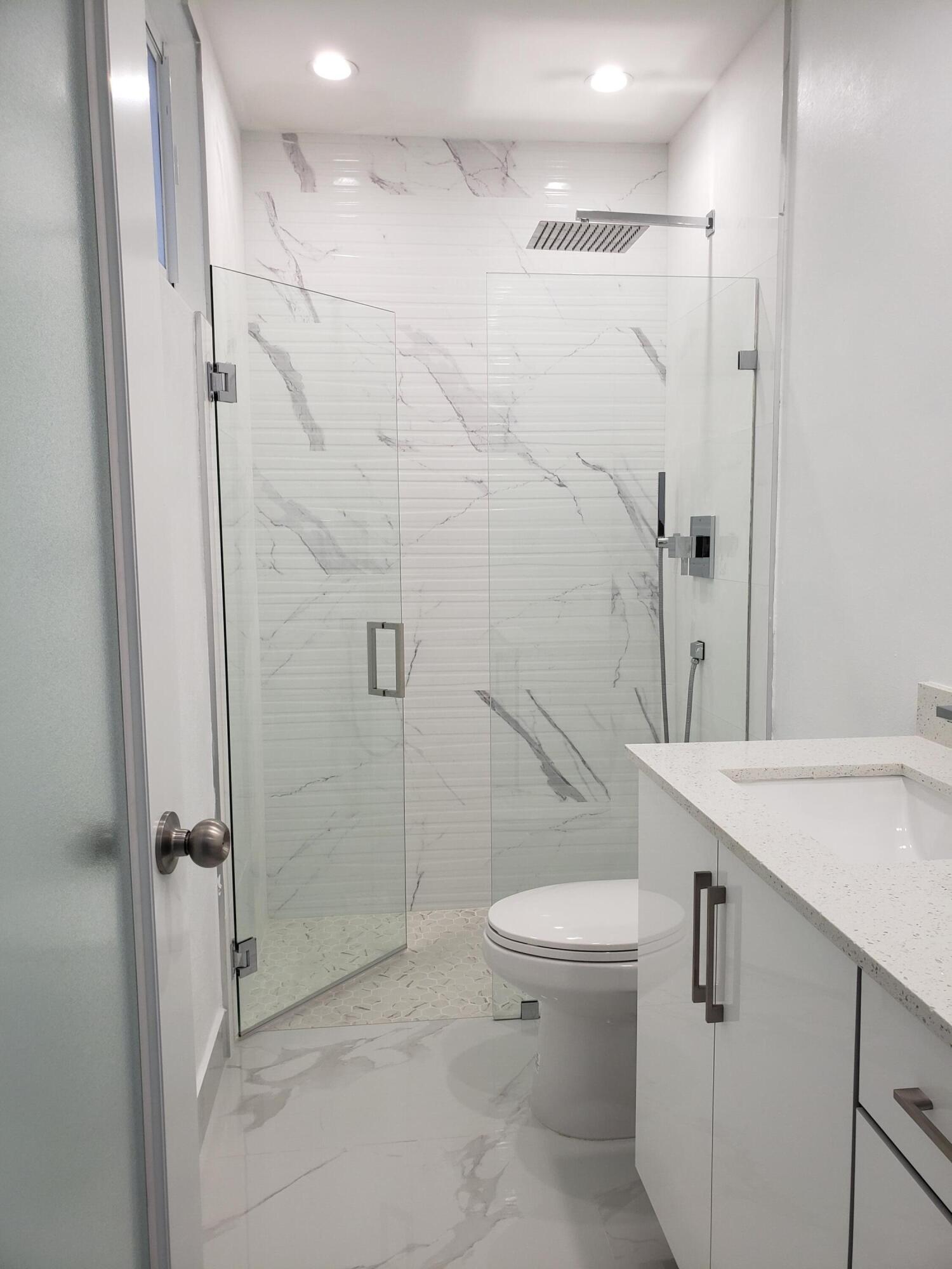 169 Corrine Place Key Largo, FL 33037 - Photo 5 of 6 a bathroom with a sink a toilet and shower