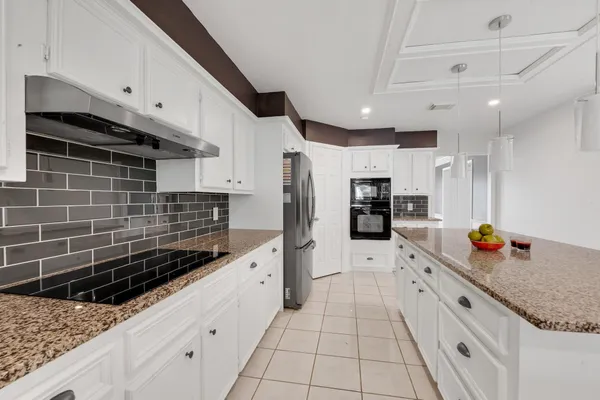 a kitchen with stainless steel appliances kitchen island granite countertop a sink and cabinets