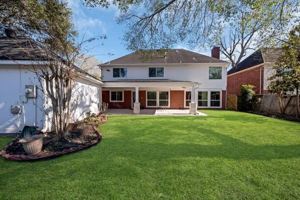 a front view of house with a garden
