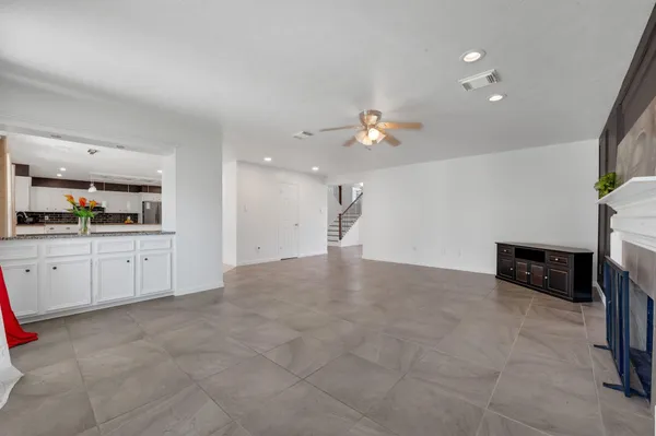 a view of a kitchen with furniture and an empty room