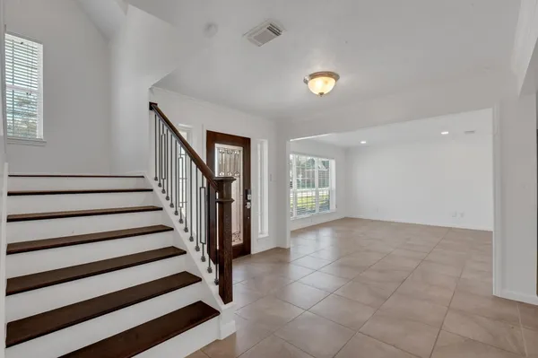a view of entryway with stairs and a window