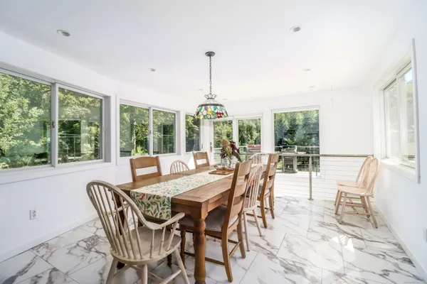 a dining room with furniture window and outside view