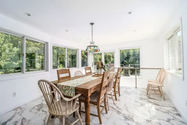 a dining room with furniture window and outside view