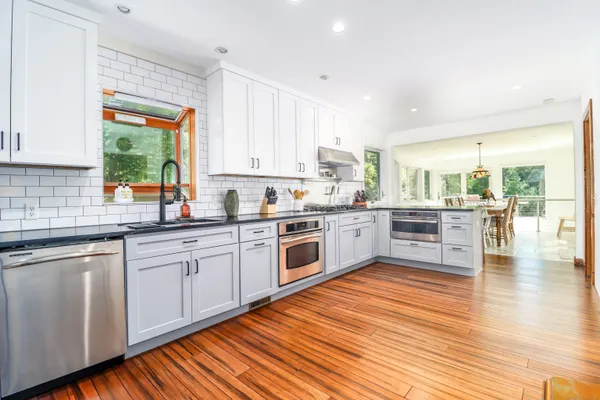 a kitchen with a sink window and cabinets