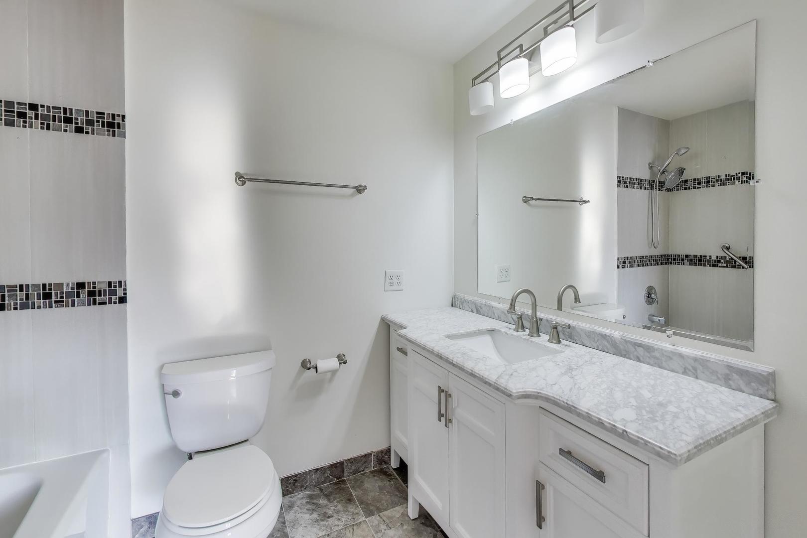 637 Bridgeview Point Schaumburg, IL 60194 - Photo 16 of 28 a bathroom with a granite countertop sink toilet and shower