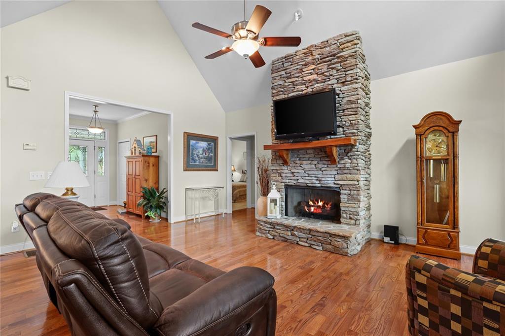1168 Highland Road Sautee Nacoochee, GA 30571 - Photo 19 of 65 a living room with furniture a flat screen tv and a fireplace