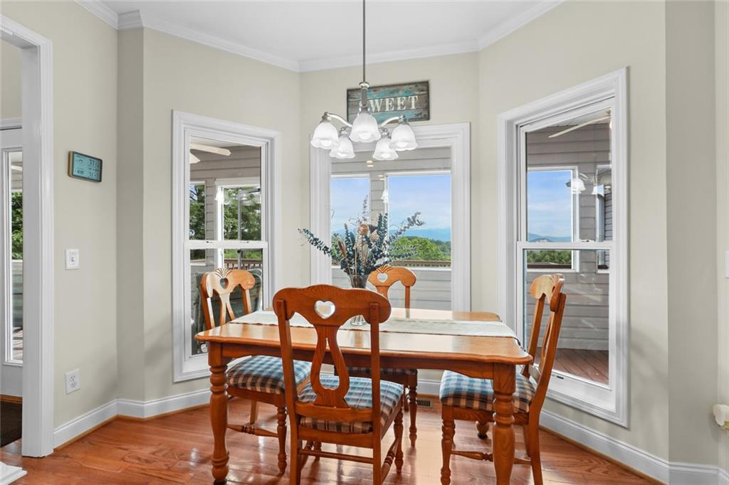 1168 Highland Road Sautee Nacoochee, GA 30571 - Photo 20 of 65 a dining room with furniture a chandelier and wooden floor