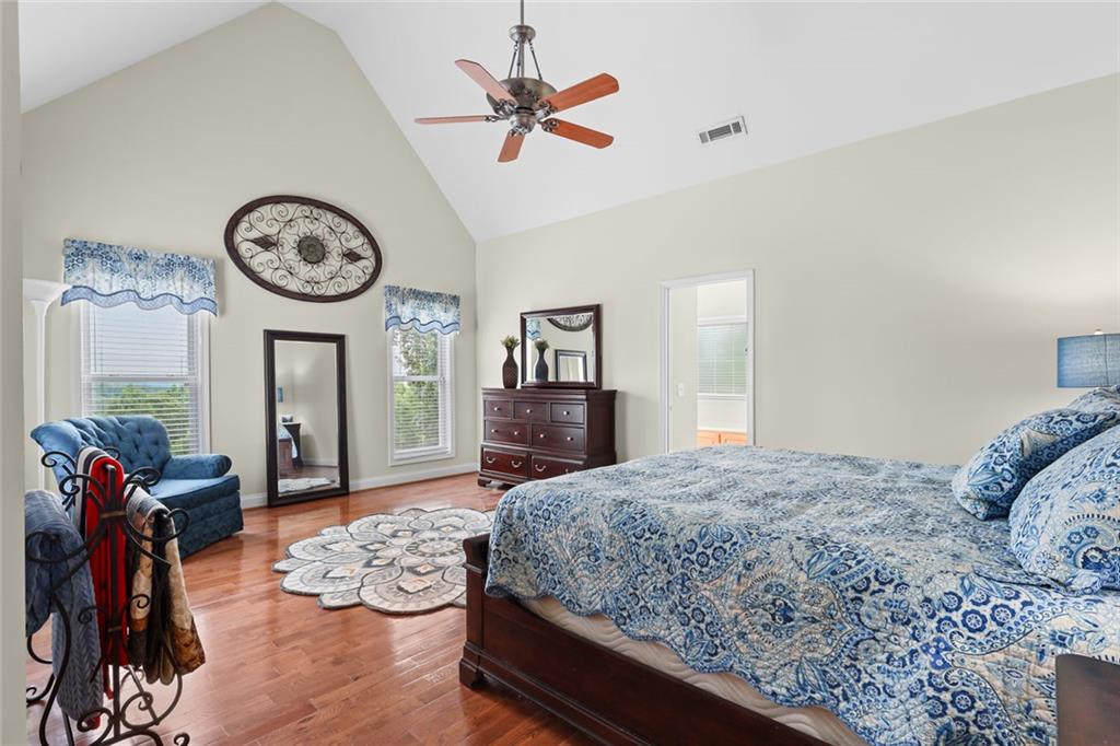 1168 Highland Road Sautee Nacoochee, GA 30571 - Photo 27 of 65 a bedroom with a bed a chandelier and dresser