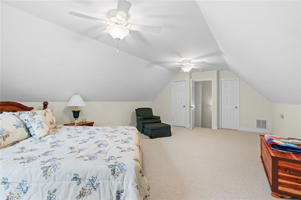 1168 Highland Road Sautee Nacoochee, GA 30571 - Photo 36 of 65 a bedroom with a bed and a chandelier