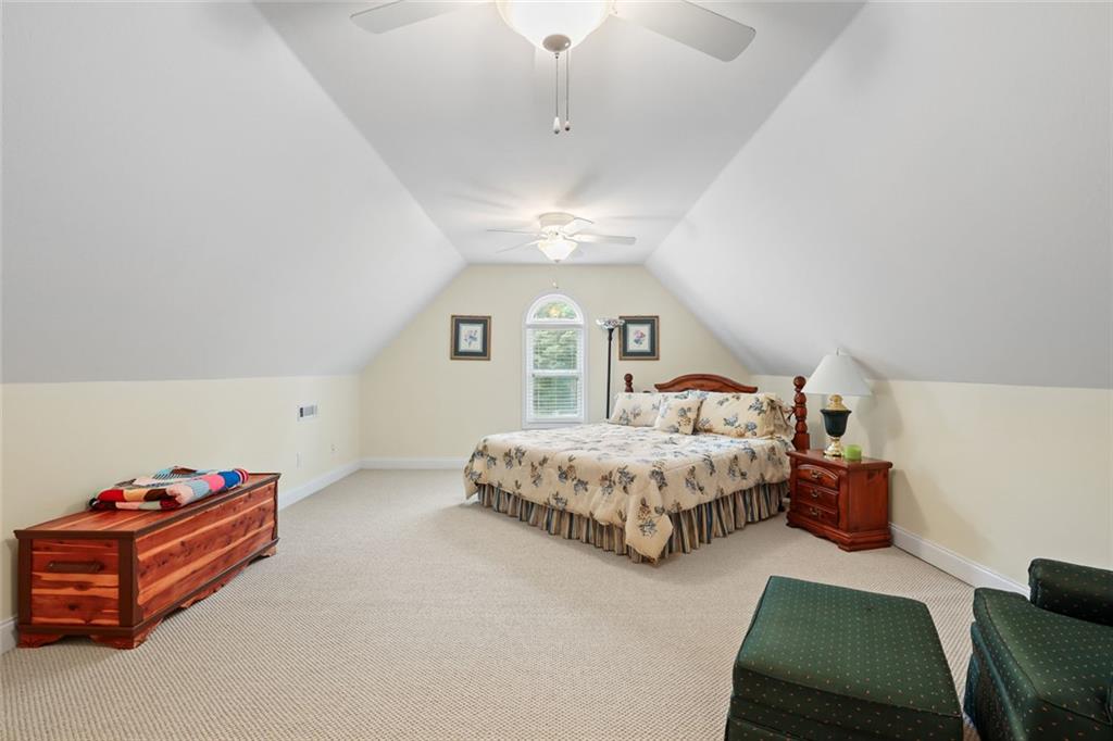 1168 Highland Road Sautee Nacoochee, GA 30571 - Photo 37 of 65 a spacious bedroom with a bed mirror and window