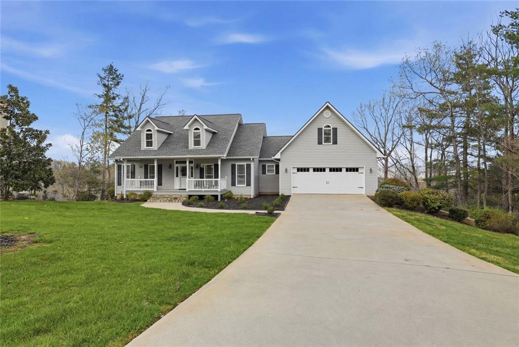 1168 Highland Road Sautee Nacoochee, GA 30571 - Photo 6 of 65 a front view of a house with a garden and trees