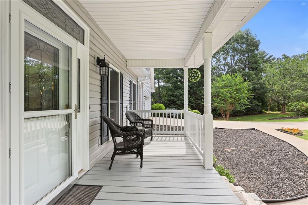 1168 Highland Road Sautee Nacoochee, GA 30571 - Photo 9 of 65 a balcony with wooden floor table and chairs