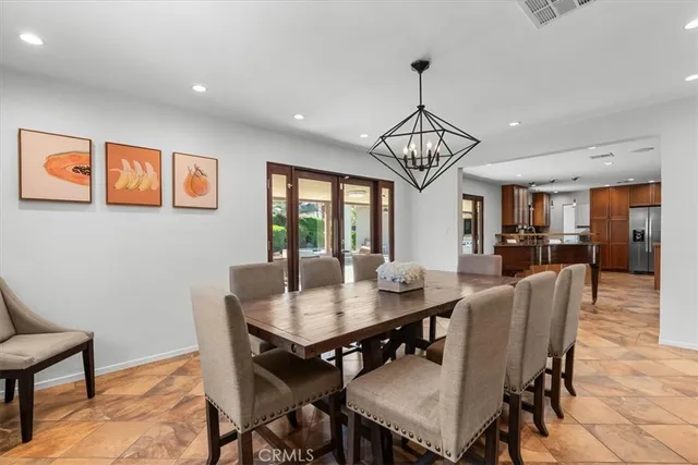 a bedroom with a bed chandelier and a window