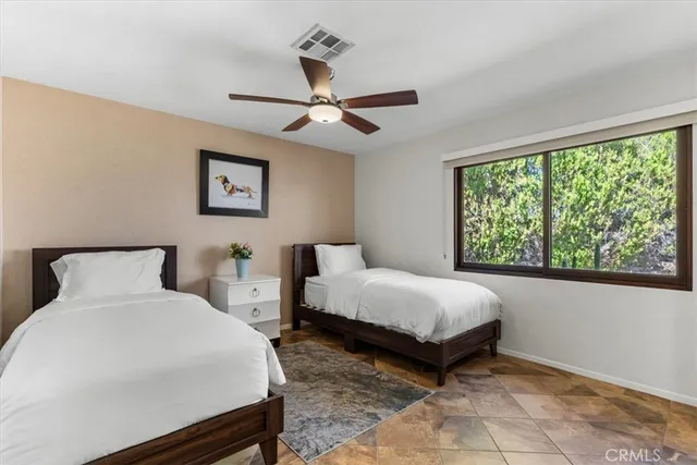 a bedroom with a large bed and a large window