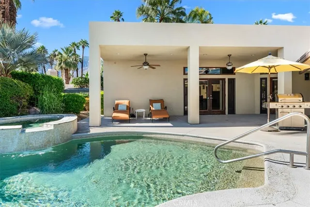 a room with furniture pool table and window