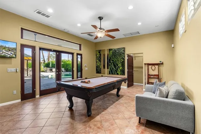 a kitchen with stainless steel appliances kitchen island granite countertop a refrigerator and a stove top oven