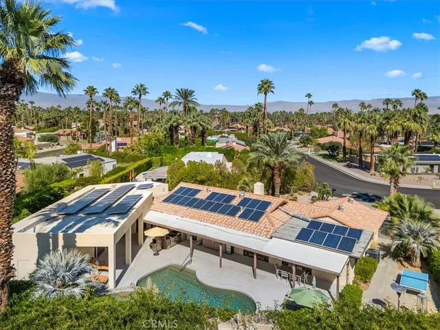 an aerial view of a house with a yard and potted plants