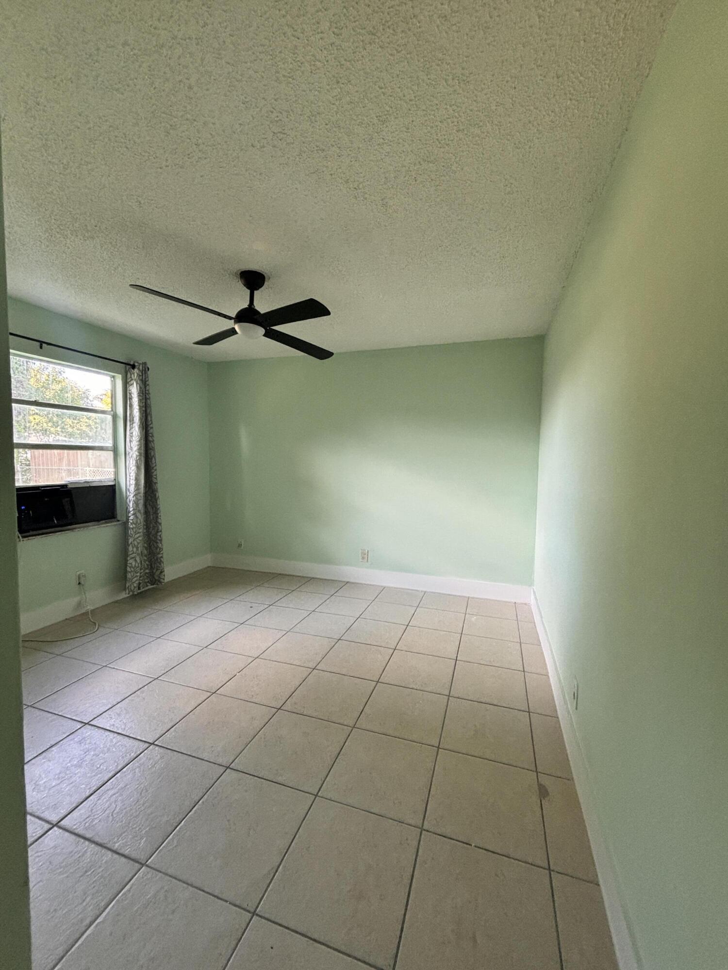 1328 West 6th Street Riviera Beach, FL 33404 - Photo 9 of 11 a view of a livingroom with an empty space and a window