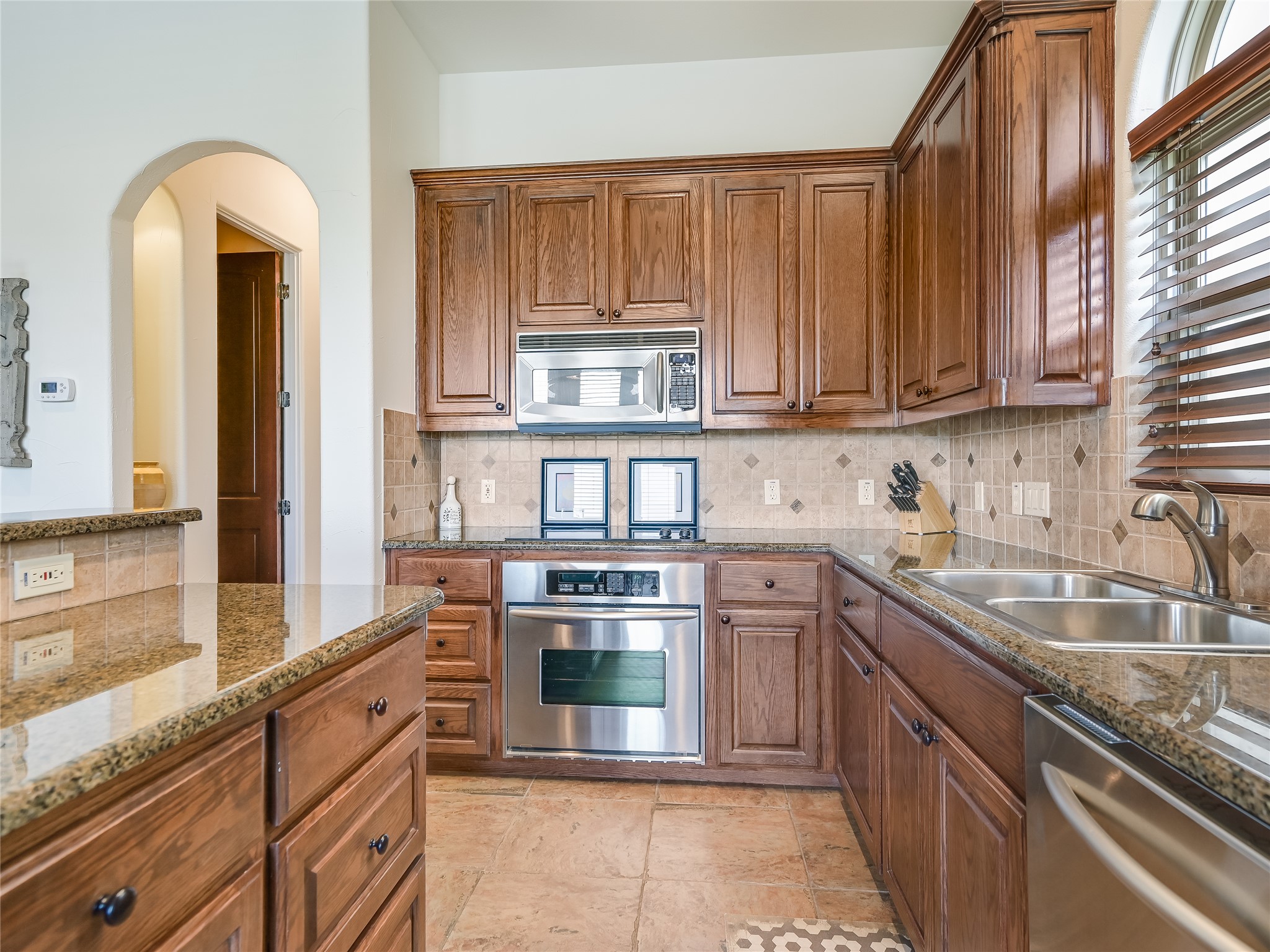 17545 West Reed Park Road, Unit 5 Jonestown, TX 78645 - Photo 12 of 26 a kitchen with stainless steel appliances granite countertop a stove and a sink