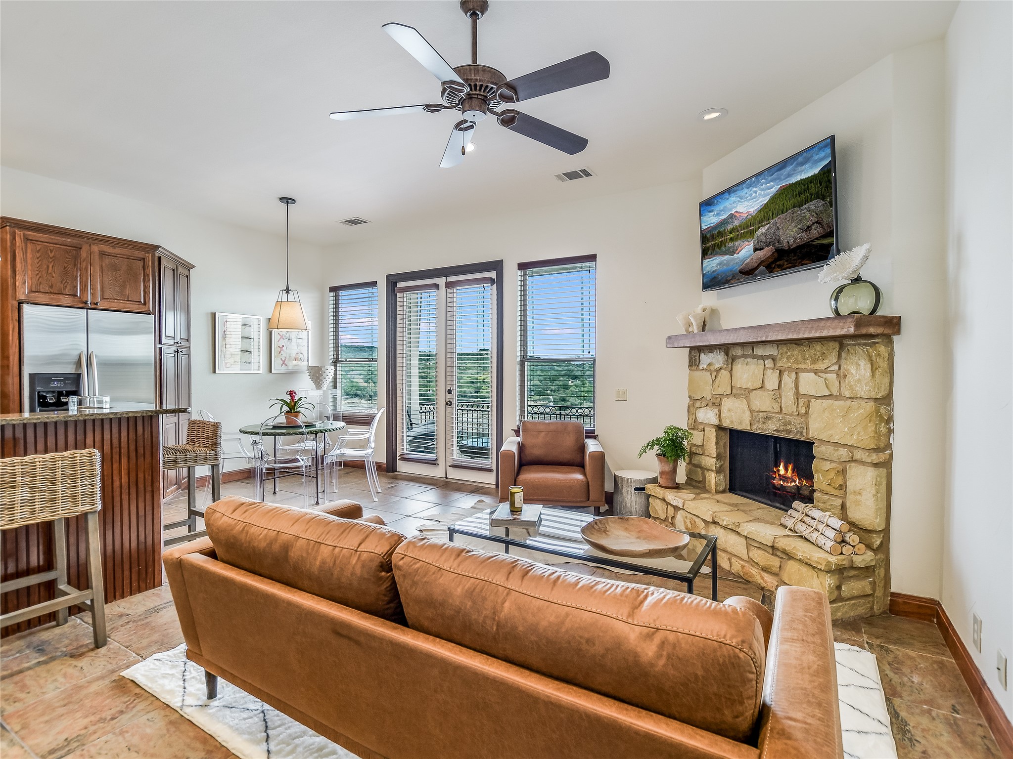 17545 West Reed Park Road, Unit 5 Jonestown, TX 78645 - Photo 2 of 26 a living room with fireplace furniture and a flat screen tv