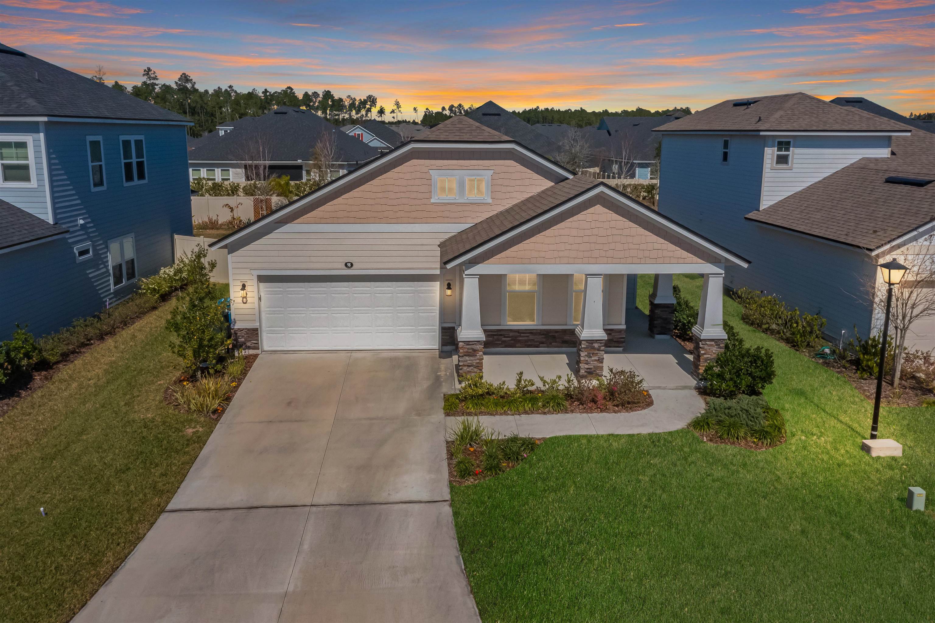 98 Windermere Way St. Augustine, FL 32095 - Photo 2 of 76 a front view of a house with a yard and garage