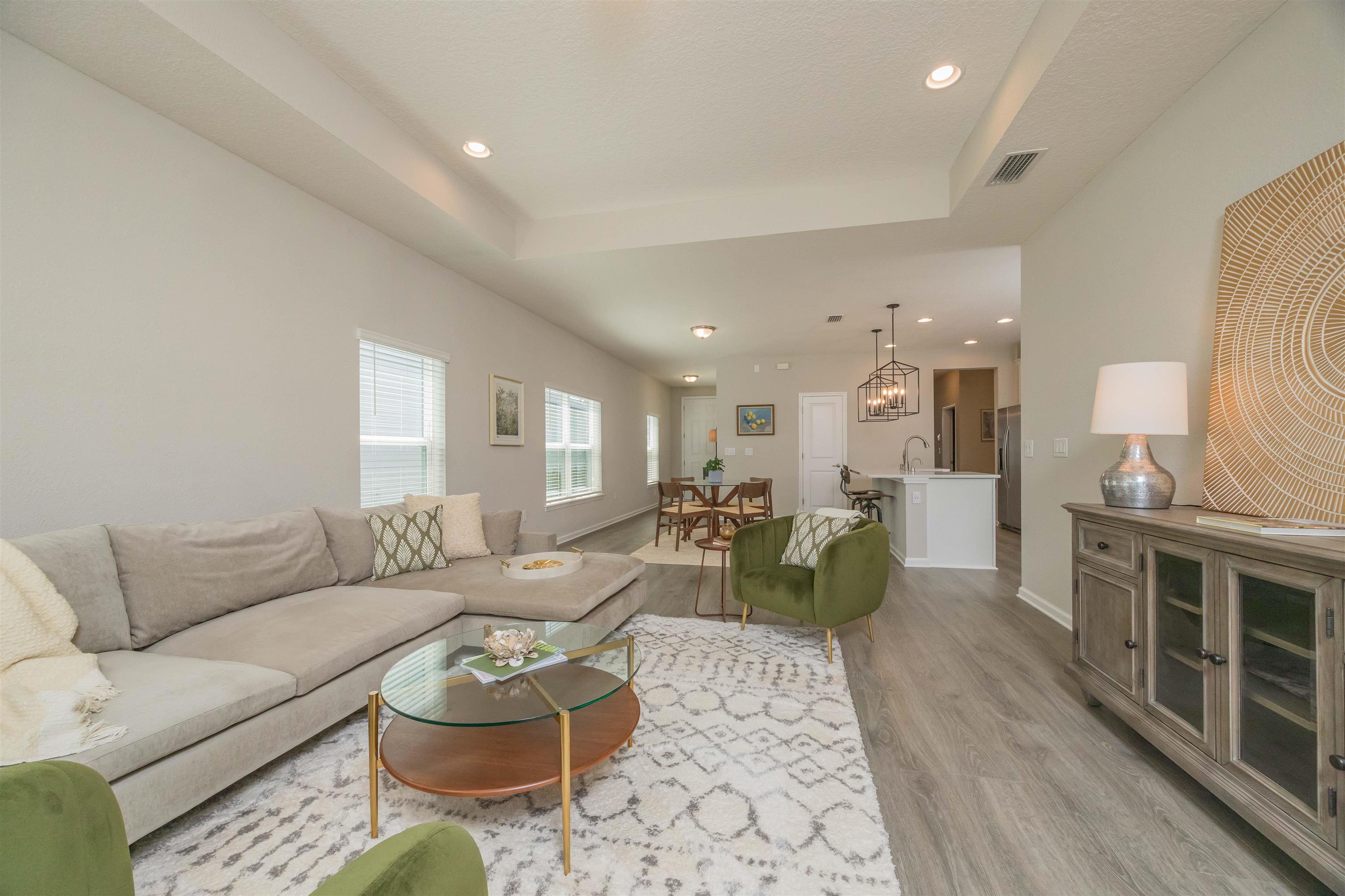 98 Windermere Way St. Augustine, FL 32095 - Photo 25 of 76 a living room with furniture and a wooden floor