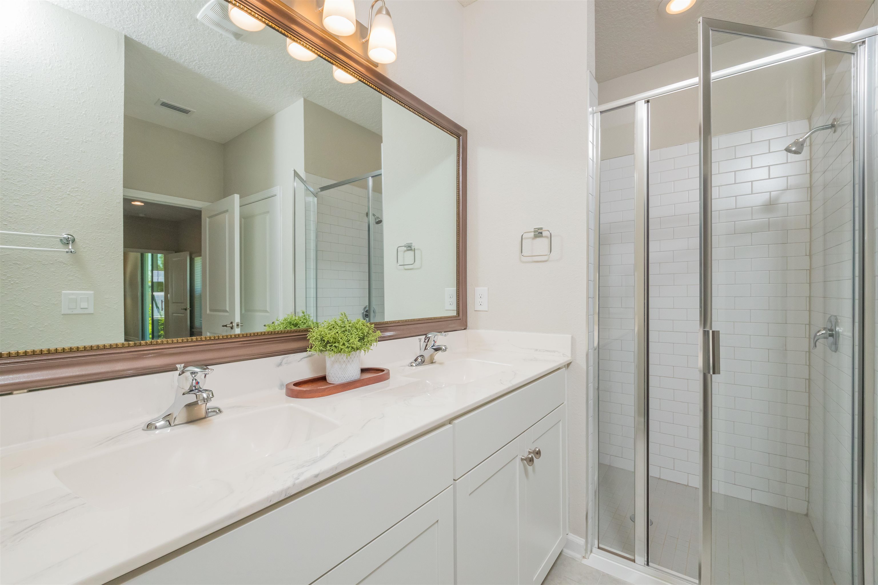 98 Windermere Way St. Augustine, FL 32095 - Photo 30 of 76 a bathroom with a sink and a mirror