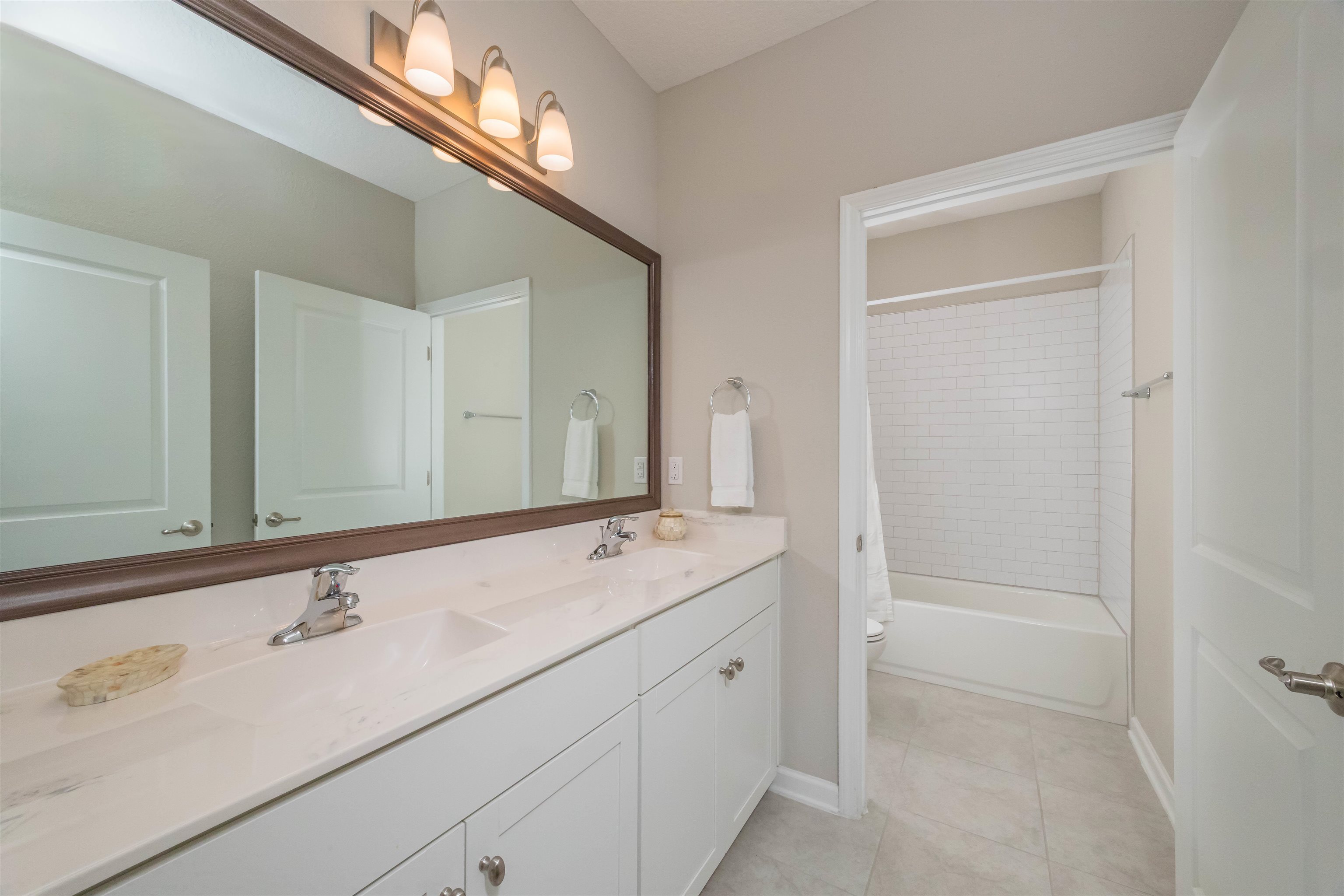98 Windermere Way St. Augustine, FL 32095 - Photo 39 of 76 a bathroom with a sink and a mirror