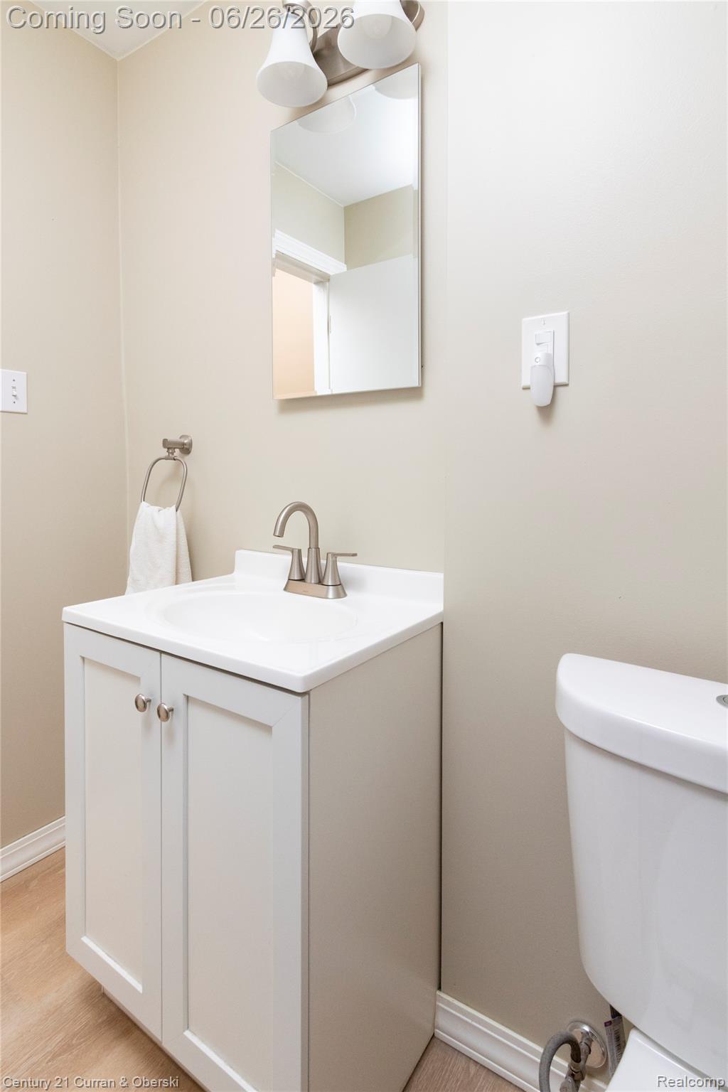 3220 Alice Street Dearborn, MI 48124 - Photo 20 of 39 White vanity with a single basin sink, brushed nickel faucet, and a rectangular wall-mounted mirror
