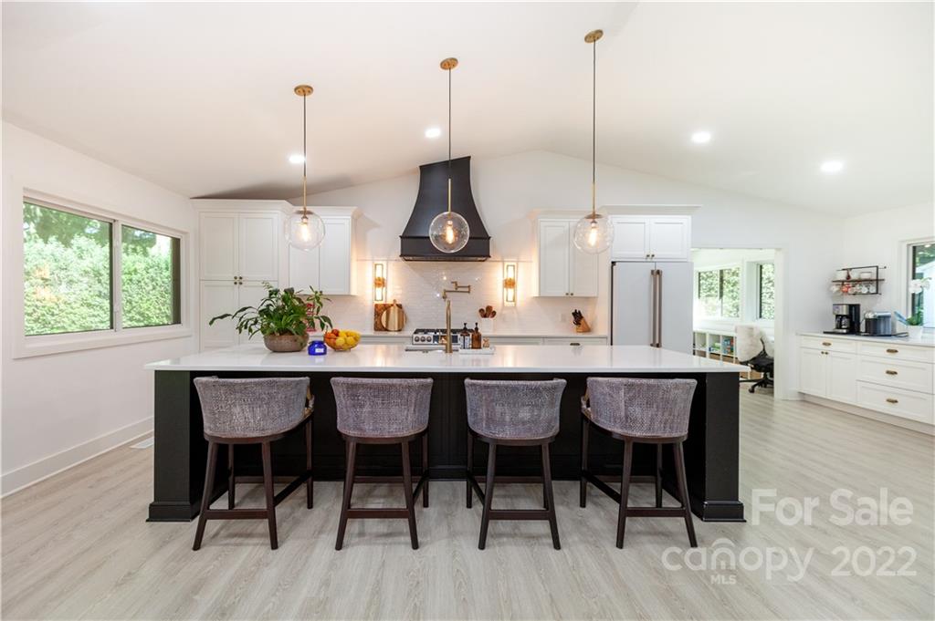 621 Wingrave Drive Charlotte, NC 28270 - Photo 14 of 48 a kitchen with stainless steel appliances granite countertop wooden floors and white cabinets