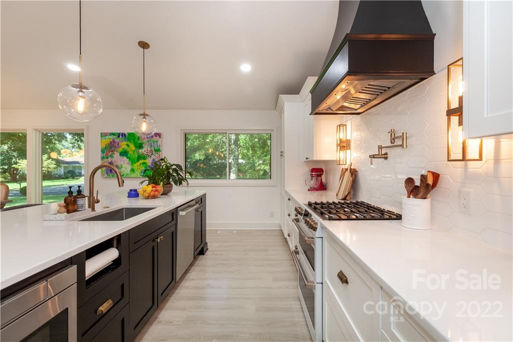 621 Wingrave Drive Charlotte, NC 28270 - Photo 15 of 48 a kitchen with kitchen island a stove a sink a counter space and a window