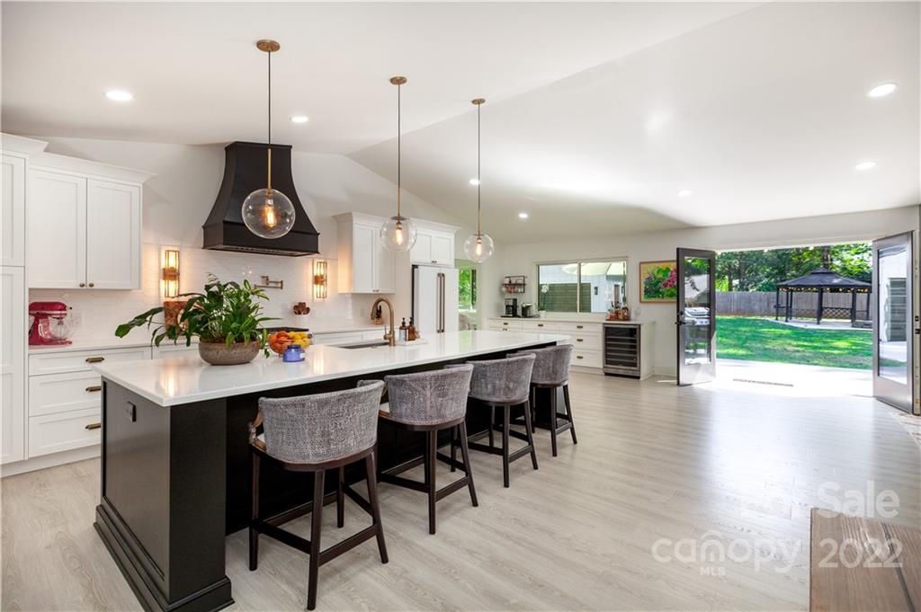 621 Wingrave Drive Charlotte, NC 28270 - Photo 16 of 48 a kitchen with stainless steel appliances granite countertop a stove a sink a oven a dining table and chairs with wooden floor