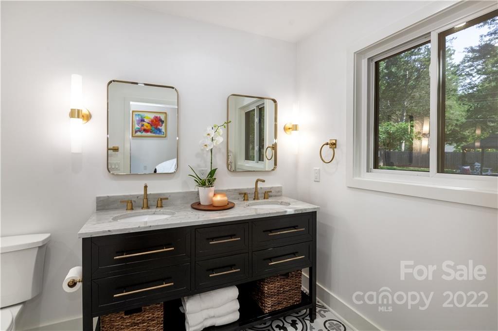 621 Wingrave Drive Charlotte, NC 28270 - Photo 34 of 48 a bathroom with a granite countertop sink a mirror and a window