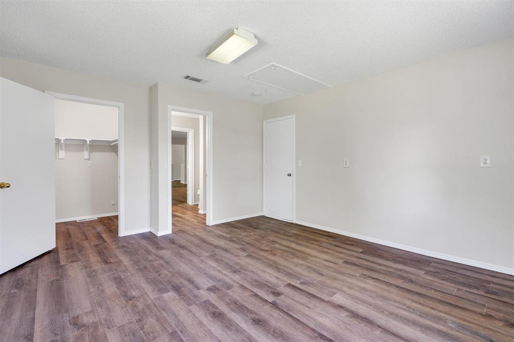 209 Mistletoe Lane Keene, TX 76059 - Photo 24 of 38 a view of an empty room with wooden floor and a window