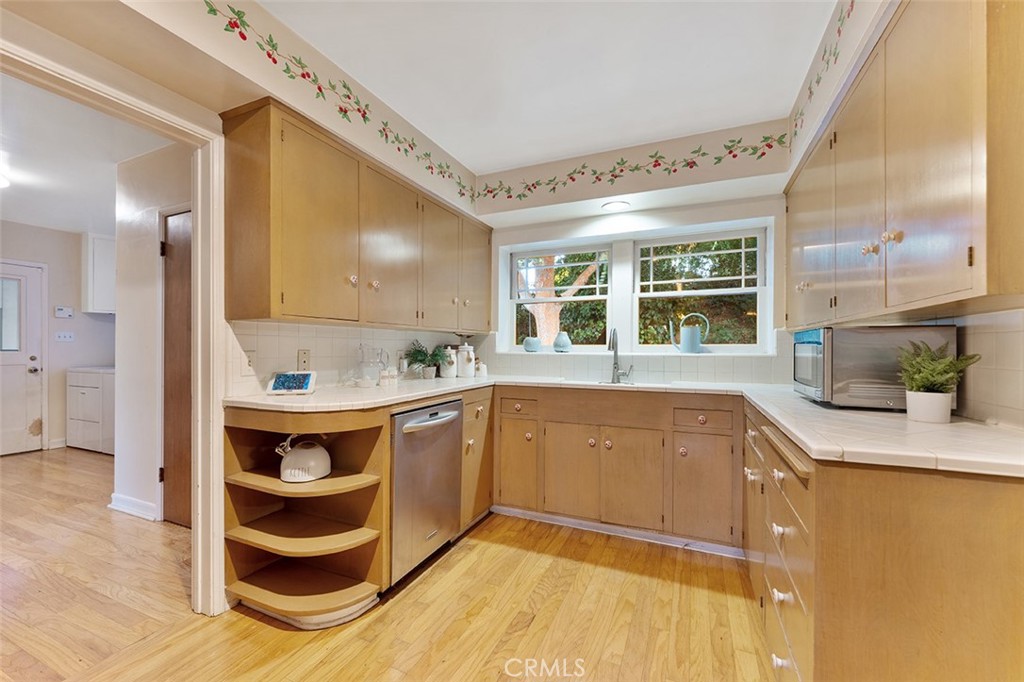 1940 Arroyo Drive Riverside, CA 92506 - Photo 12 of 50 Original galley kitchen. Doorway to the left leads to roomy laundry and walk in pantry and access to a 3/4 bathroom as well as a door to the breezeway across from the garage.