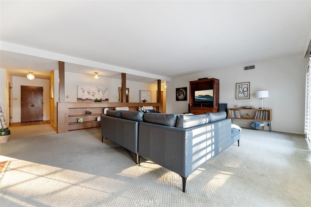 1940 Arroyo Drive Riverside, CA 92506 - Photo 20 of 50 Formal living room with open hallway and built ins and formal entry in the distance.