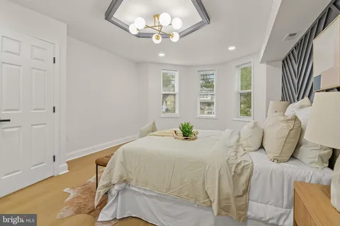 a bedroom with a bed and a chandelier