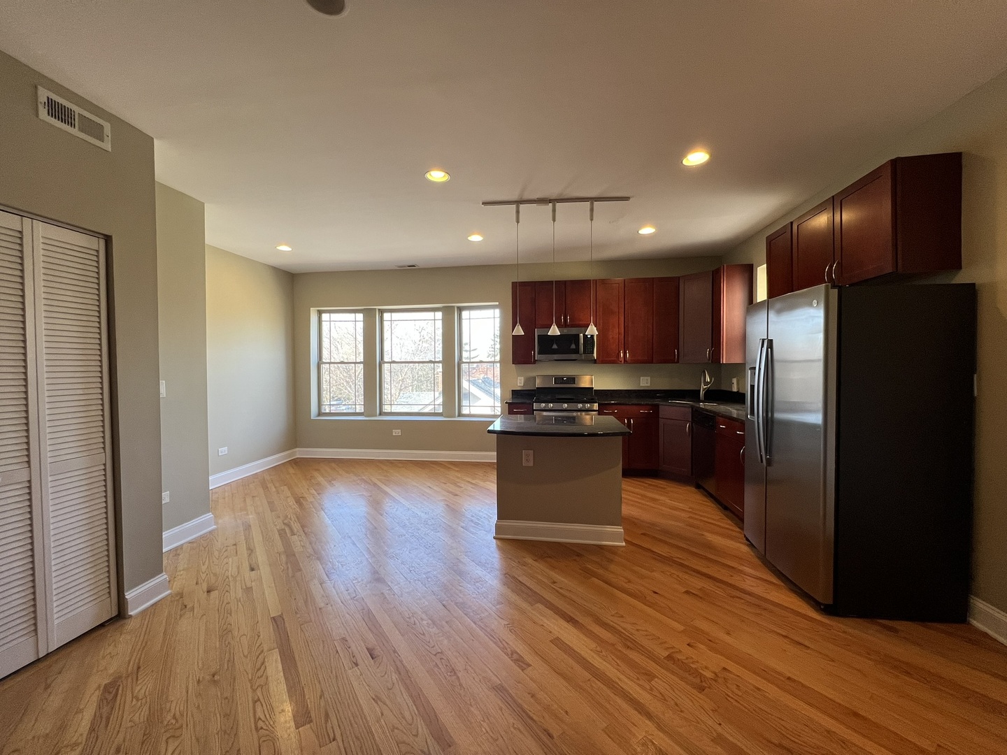 911 Maple Avenue, Unit 3N Evanston, IL 60202 - Photo 12 of 18 a kitchen with a refrigerator and a stove top oven