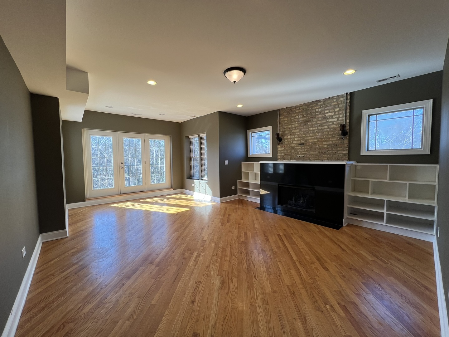 911 Maple Avenue, Unit 3N Evanston, IL 60202 - Photo 2 of 18 an empty room with wooden floor and fireplace