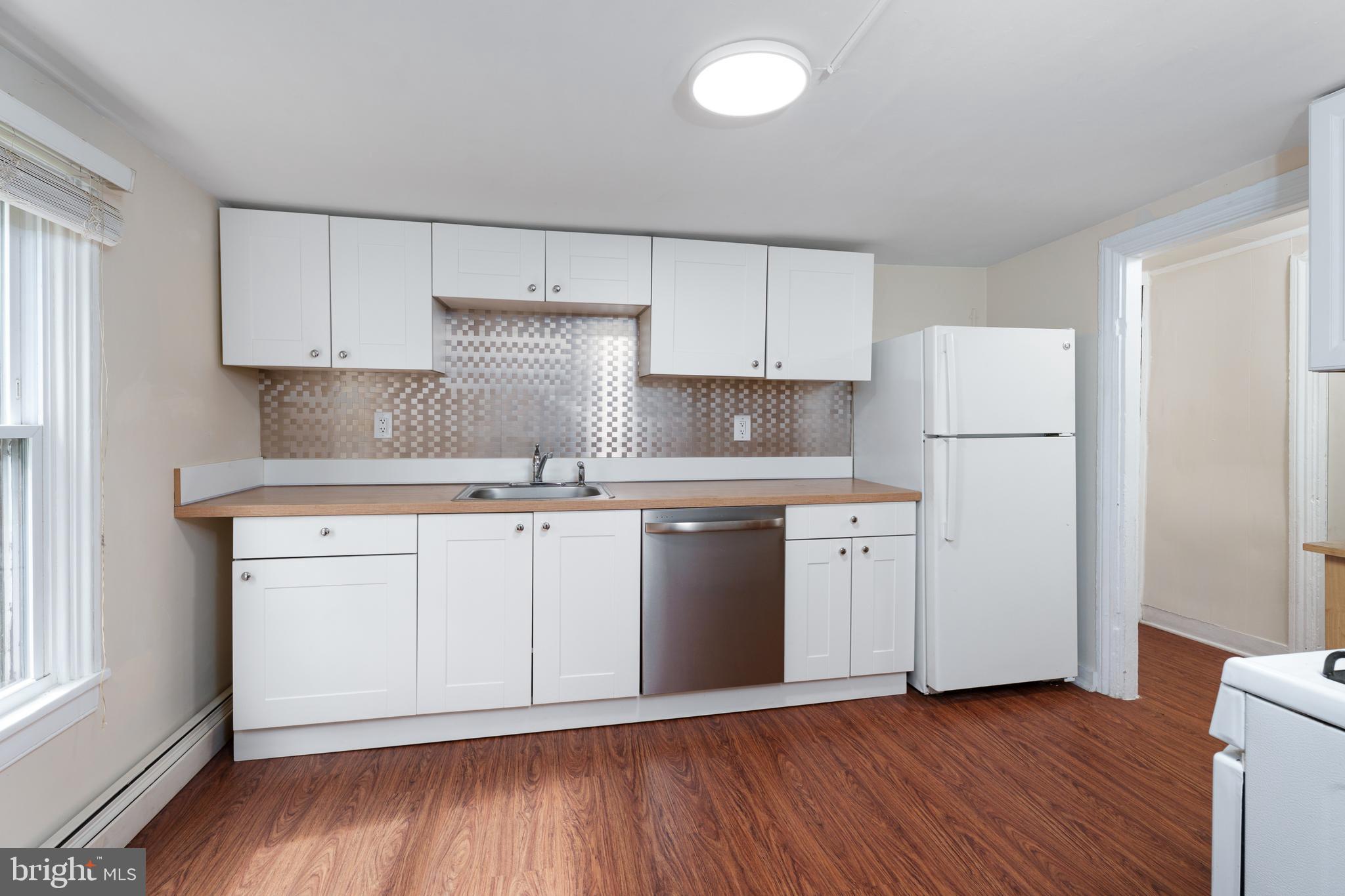 124 Washington Road, Unit 2 Princeton, NJ 08540 - Photo 4 of 13 a kitchen with white cabinets white stainless steel appliances and sink