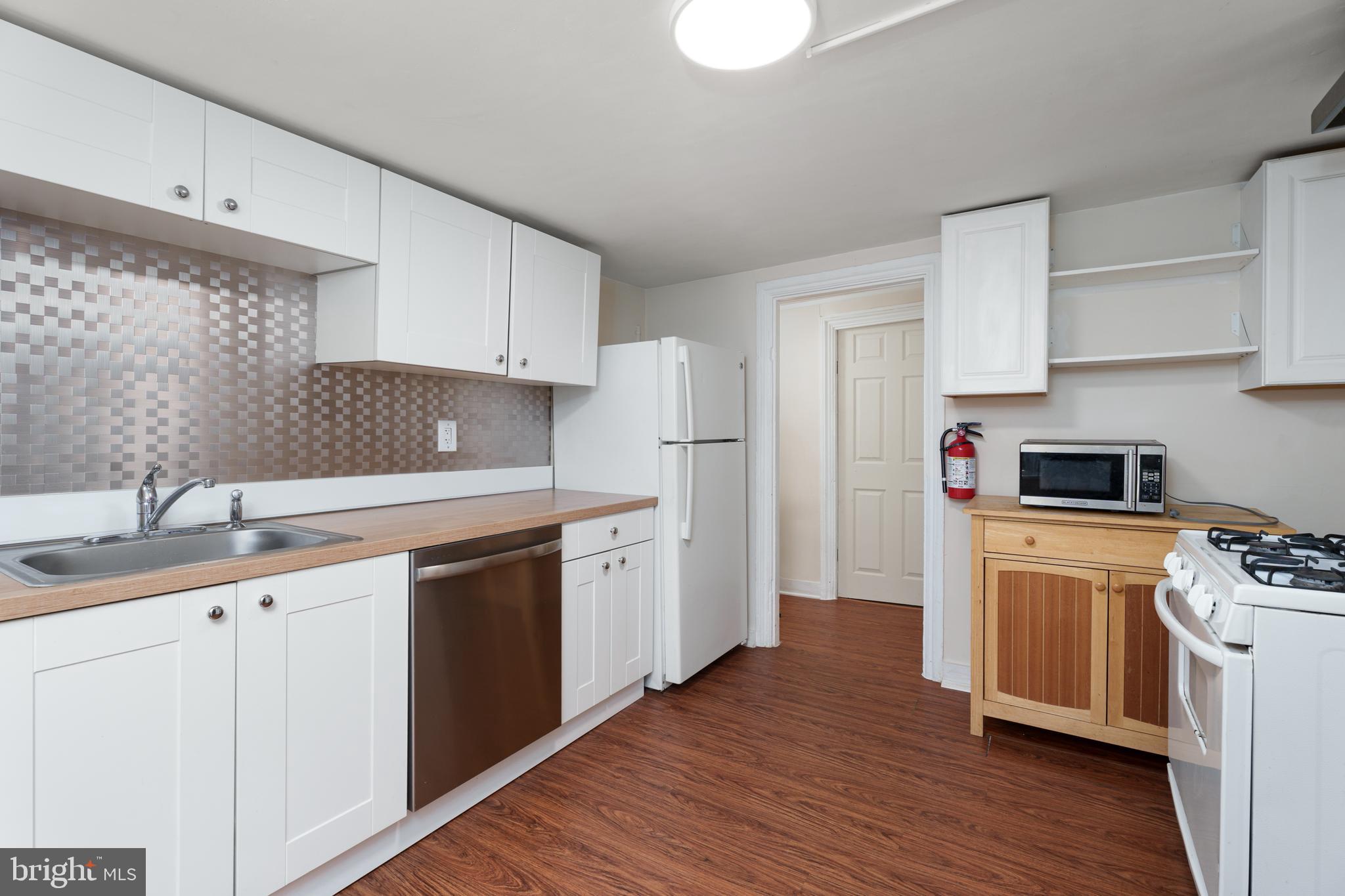 124 Washington Road, Unit 2 Princeton, NJ 08540 - Photo 5 of 13 a kitchen with cabinets stainless steel appliances a sink and wooden floor