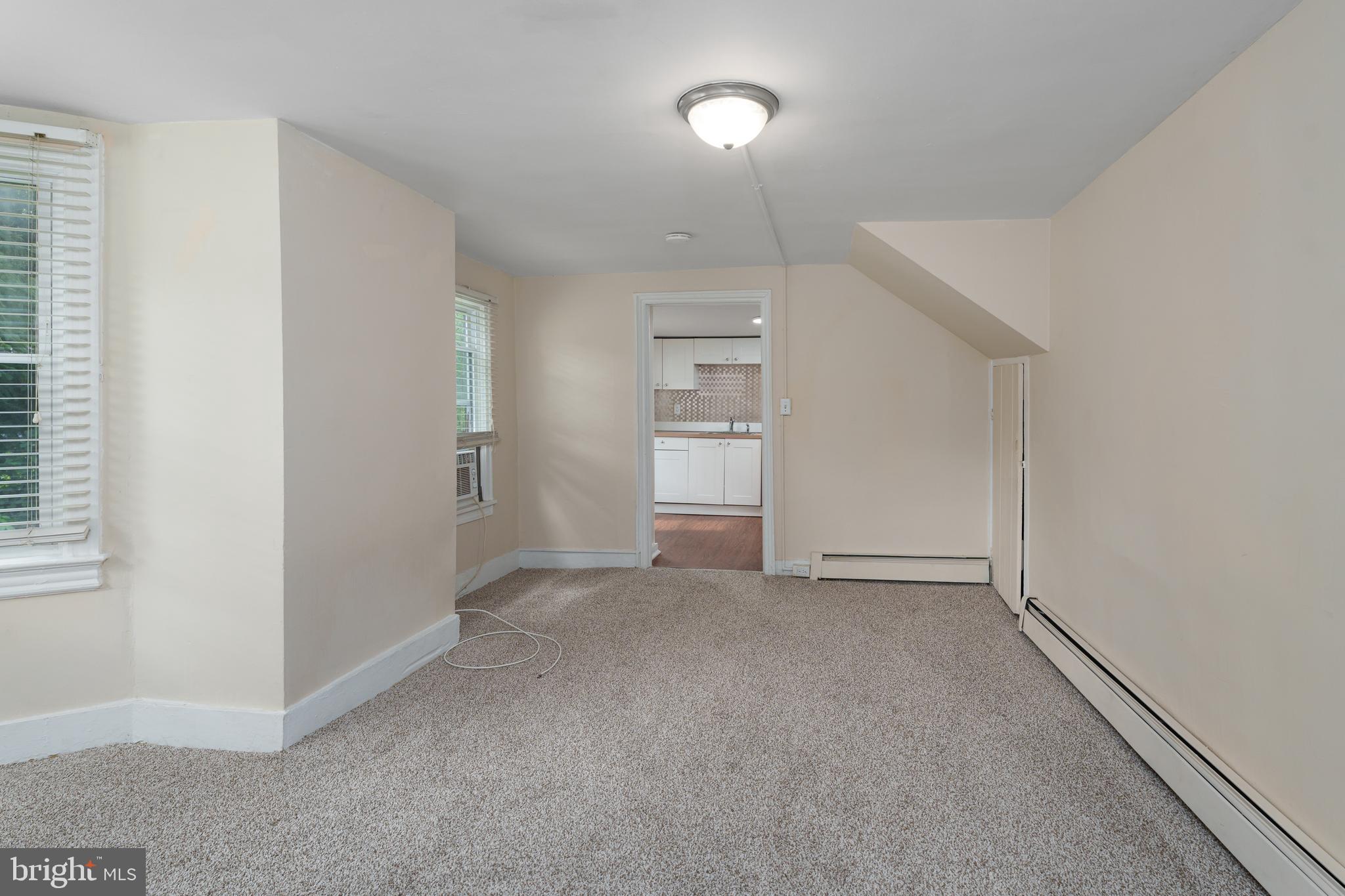 124 Washington Road, Unit 2 Princeton, NJ 08540 - Photo 9 of 13 an empty room with closet and windows